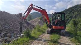 A hydraulic breaker being used to break rock