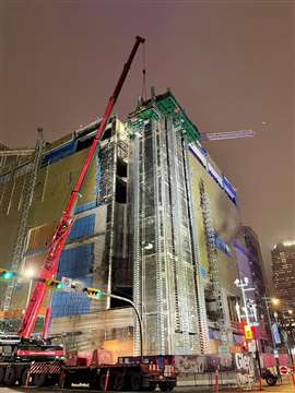 A crane lifting a concrete lab from the Northeast stairwell of the Glenbow Museum