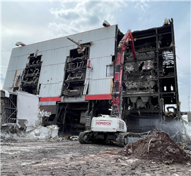 A high reach excavator demolishing the Detroit Waste Energy Facility