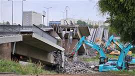 Centro's excavators work on the riverbank to demolish the bridge