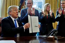 US President Donald Trump signs an executive order in 2018 (Image: REUTERS/Carlos Barria)