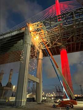 Gerald Desmond Bridge - worker in a MEWP performing torch cutting on theanchor span