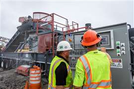 site workers operating a Superior Industries cone crusher controls