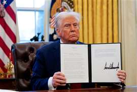 President Trump holding a signed exective order at the White House