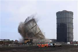 The gas holder structure falling after the explosive demolition